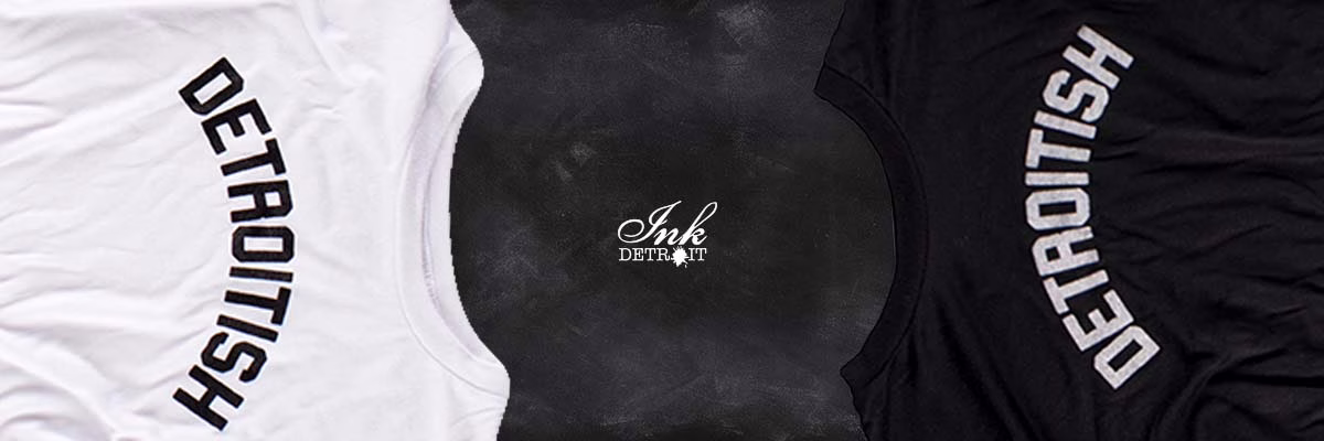 Ink Detroit logo on dark wood texture